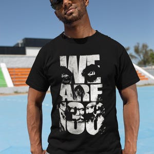 May include: A black t-shirt with a white graphic print of a face with the words "WE ARE 130" on it.