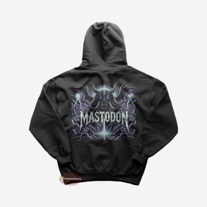 May include: Black hooded sweatshirt with a graphic print of a monster with the text "MASTODON" on the back.