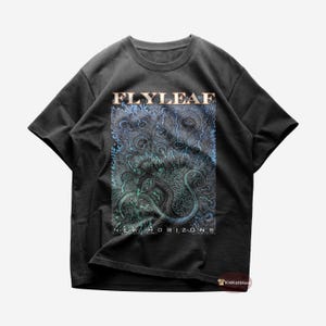 May include: Black t-shirt with a graphic print of a blue and green creature with the text "FLYLEAF NEW HORIZONS" on the front.