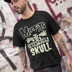 May include: Black t-shirt with a white graphic of a skull with the text "Misfits I Want Your Skull".