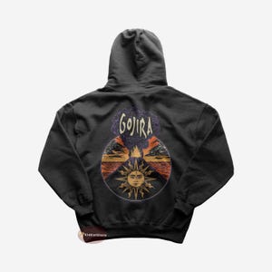 Op de afbeelding: Een zwart hoodie met een grafische print van een zon en een vulkaan met het woord "GOJIRA" erboven.