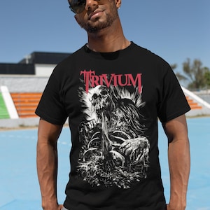 May include: A black t-shirt with a white graphic of a skull and the word "TRIVIUM" in red letters.