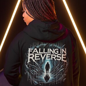 May include: Black hooded sweatshirt with a graphic print of a figure standing in a dark forest with the text "Falling in Reverse" above the figure.