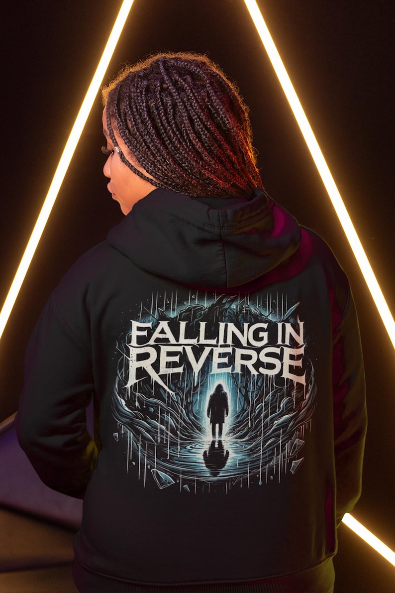 May include: Black hooded sweatshirt with a graphic print of a figure standing in a dark forest with the text "Falling in Reverse" above the figure.
