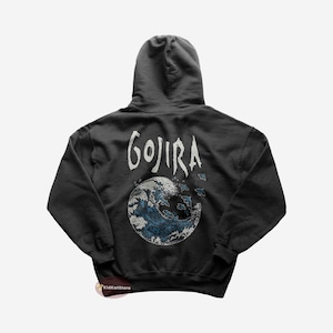 May include: Black hooded sweatshirt with a white graphic of a wave and the word "GOJIRA" on the back.