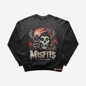 May include: Black sweatshirt featuring a graphic print of a skull with flames and the text "Misfits Horror Punk".