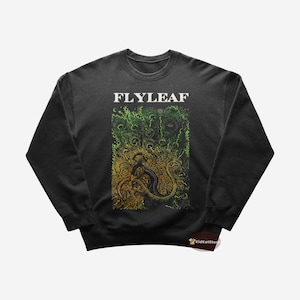 May include: Black sweatshirt with a green and yellow graphic print of a creature with the band name "FLYLEAF" in white text.