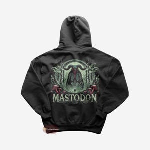 May include: Black hooded sweatshirt with a green, red, and white graphic of a skeletal creature with horns and the text "MASTODON".