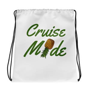 May include: White drawstring bag with the text "Cruise Mode" in green lettering and a pineapple graphic.