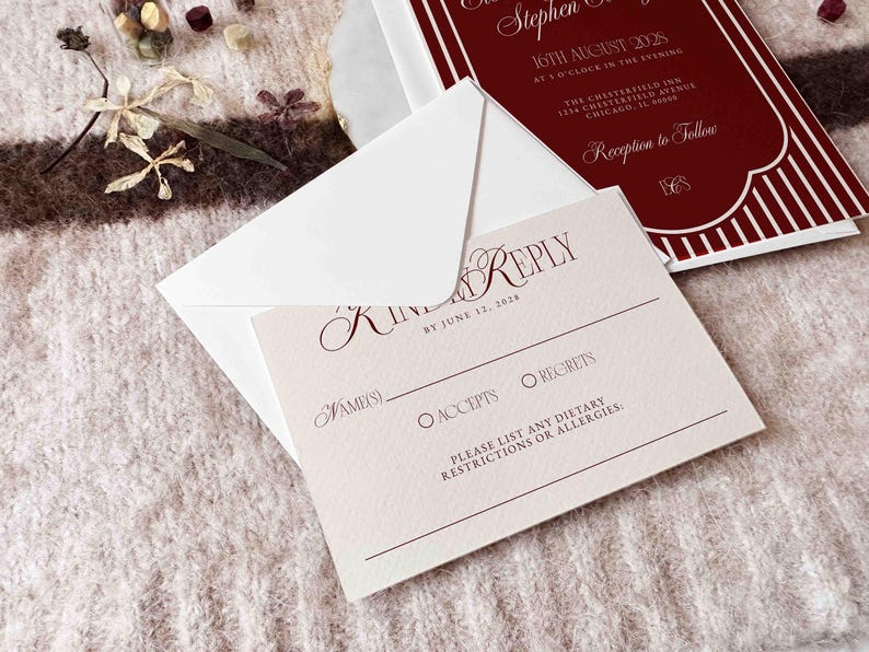 May include: A wedding invitation suite featuring a burgundy and white design. The invitation card includes the event details, while the RSVP card has fields for the guest's name, acceptance, or regrets, and dietary restrictions. The suite is accompanied by a white envelope.