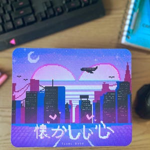 May include: A square sticker with a pixelated cityscape design in shades of purple, blue, and pink. The design includes a moon, a setting sun, buildings, and an airplane. Japanese text is at the bottom, with the text "Tixel Byte" below it.
