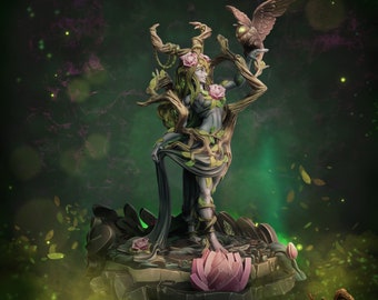 May include: A green and brown miniature figurine of a female figure with a tree growing from her body. She is holding a small owl in her hand. The figurine is standing on a base with a pink lotus flower. The text "Faythe #361" and "Ancient Woodlands Collection" is visible in the image.