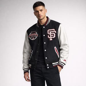 Op de afbeelding: Zwarte varsity jas met witte mouwen. Voorzien van het San Francisco Giants logo en letters in rood en wit. Inclusief een patch met de tekst "World Series Giants 1941".