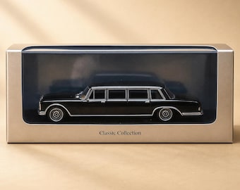 May include: A black die-cast limousine model car displayed inside a rectangular gold-toned box with a clear plastic window. The box features the text Classic Collection printed in black on the front lower center of the packaging.