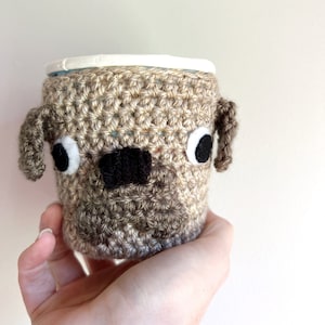 Pug dog crochet cozy covering a Ben & Jerry’s Pint sized ice cream tub