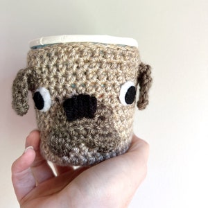 Pug dog crochet cozy covering a Ben & Jerry’s Pint sized ice cream tub