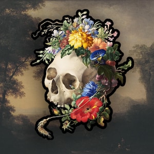 May include: A white human skull with a floral crown of colorful flowers, including red, yellow, blue, and purple flowers. The skull is surrounded by a dark background.
