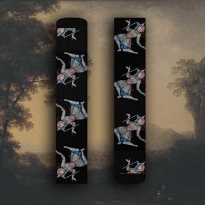 May include: Black socks featuring a repeating pattern of a medieval figure in armor, holding a spear. The figure is depicted in shades of red, blue, and silver. The socks are a unique accessory.
