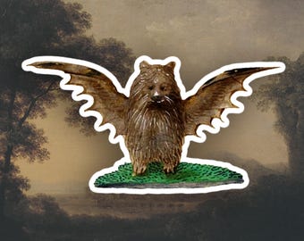 May include: A brown, furry creature with bat wings, standing on a green base. The creature has a long snout and large, pointed ears. The background is a painting of a landscape with trees and a river.