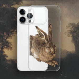 May include: A clear phone case featuring a brown rabbit illustration. The rabbit is facing the right side of the image with its ears perked up. The phone case has a white background and a black outline around the rabbit.