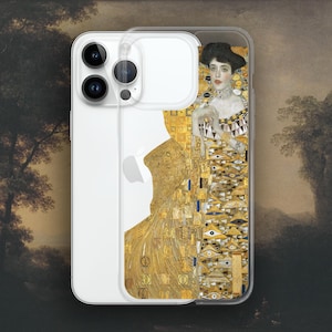 May include: Clear phone case featuring a famous painting by Gustav Klimt. The artwork depicts a woman in a gold and patterned dress, with a black hat and a detailed background. The phone case is designed to fit a smartphone.