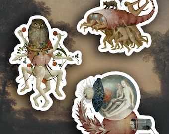 May include: Set of three die-cut stickers featuring surrealist art. One sticker depicts a figure with an owl head, another shows a creature with a shell, and the last one has a glass orb with figures inside.