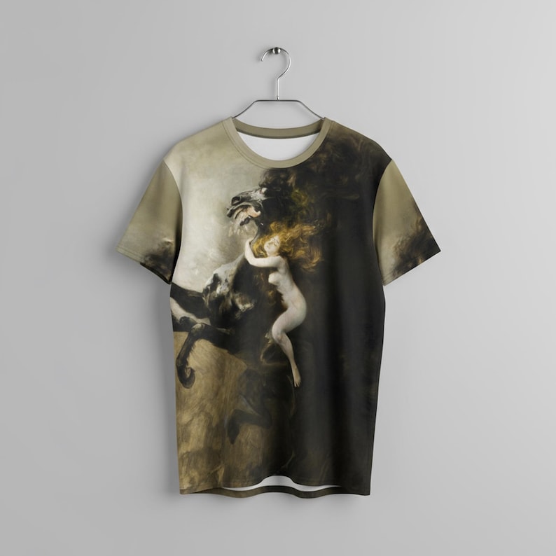 May include: A short-sleeved t-shirt featuring a classical painting of a woman embracing a dark, horse-like creature. The artwork is in shades of brown, black, and beige, with the woman's form in a lighter tone. The shirt is hanging on a metal hanger.
