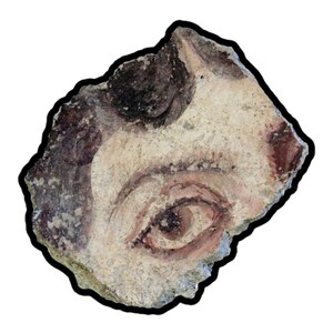 May include: Fragment of an ancient fresco depicting a human eye and part of the face. The eye is painted with shades of brown and red, with a light beige background. The edges of the fragment are irregular, with a black outline.