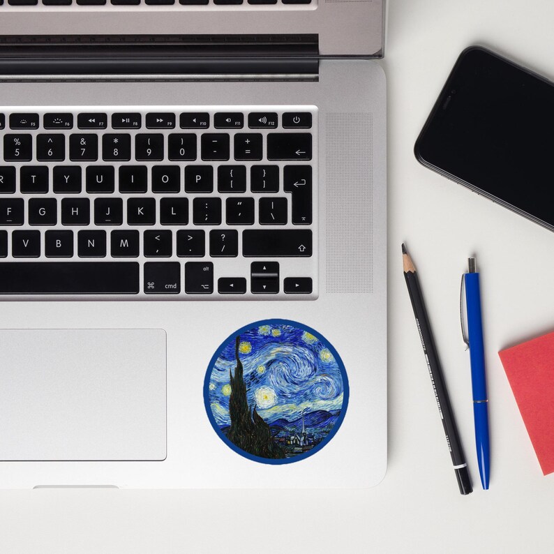 May include: A round sticker featuring Vincent van Gogh's "The Starry Night" painting. The sticker has a dark blue border and depicts a swirling night sky with stars, a cypress tree, and a village.