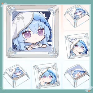 May include: Clear acrylic keycaps featuring a cartoon character with blue hair and a white bonnet. The character has large purple eyes and is set against a white background. The keycaps are square and have a glossy finish.