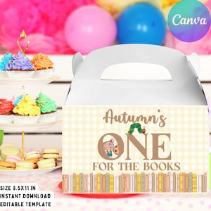 May include: A white cardboard gable box featuring a light yellow gingham pattern, the text "Autumn's ONE FOR THE BOOKS," a small caterpillar illustration, and a row of colorful book spines at the bottom, designed as a printable party favor container.