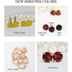 May include: Four sets of earrings featuring 8mm Swarovski crystal stones in various colors. The colors are yellow opal, light Siam red, Siam red, and scarlet red. The earrings are made with gold-plated settings.  NEW 8MM/39SS COLORS.