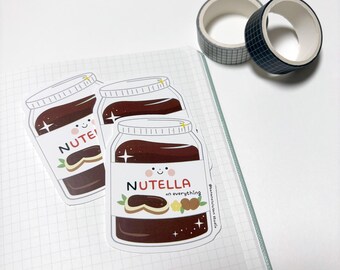 May include: Three stickers featuring a jar of Nutella with a smiling face and the text "Nutella on everything." Two rolls of decorative washi tape with grid and crosshatch patterns are also visible.