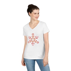 May include: White V-neck t-shirt with a red and yellow floral design featuring birds. The design is centered on the shirt.
