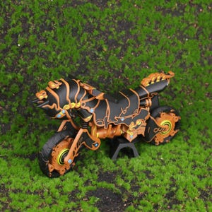 3D printed replica of the Master Cycle Zero from The Legend of Zelda: Breath of the Wild and Tears of the Kingdom, displayed at an angle to highlight the detailed design, mechanical accuracy, and game-authentic black and orange color tones. The image showcases the intricate body structure and the spring-loaded suspension system on both wheels, emphasizing its realism and appeal to gaming fans and collectors. Ideal for use as a centerpiece in a gaming room, office shelf