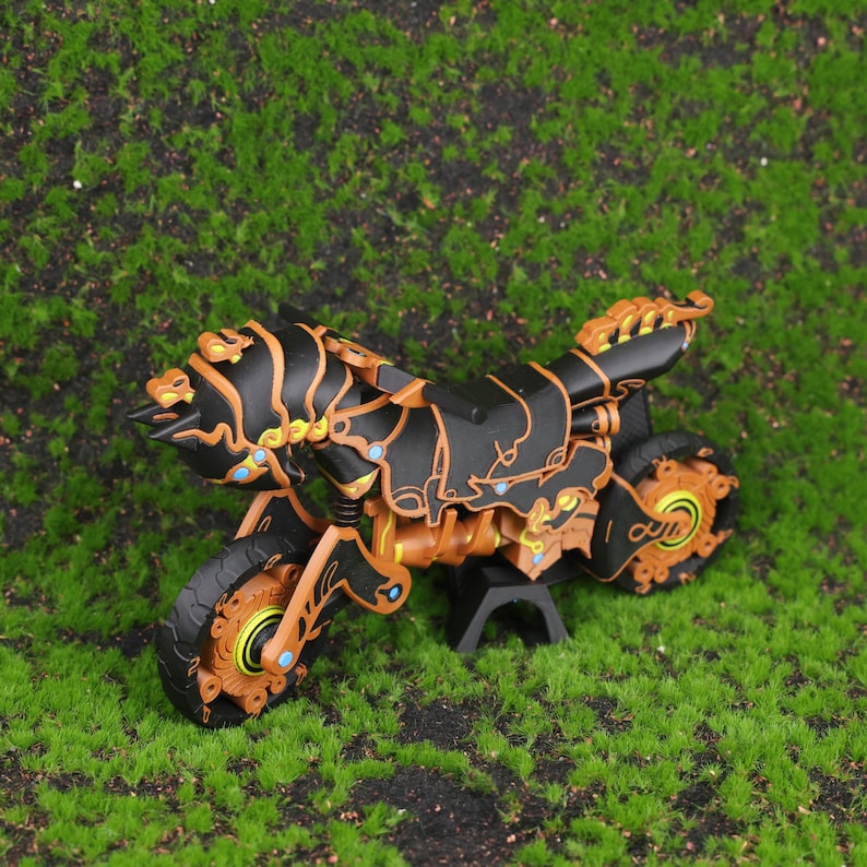 3D printed replica of the Master Cycle Zero from The Legend of Zelda: Breath of the Wild and Tears of the Kingdom, displayed at an angle to highlight the detailed design, mechanical accuracy, and game-authentic black and orange color tones. The image showcases the intricate body structure and the spring-loaded suspension system on both wheels, emphasizing its realism and appeal to gaming fans and collectors. Ideal for use as a centerpiece in a gaming room, office shelf