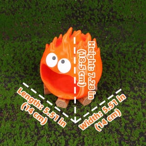 Close-up image of the Fire Demon Calcifer 3D printed storage box showing detailed craftsmanship, smooth surface finish, and the vibrant orange color. Designed as a functional desktop organizer, the product offers a practical yet fun solution to storing small office essentials. Inspired by Howl’s Moving Castle, it makes an excellent collectible item or anime-themed gift for birthdays, holidays, or special occasions.