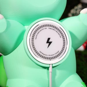 Adorable phone charging station featuring a plant-inspired creature design, perfect for gaming lovers. A versatile and decorative phone holder ideal for fans of whimsical, eco-friendly accessories. Fast MagSafe charging and reliable support