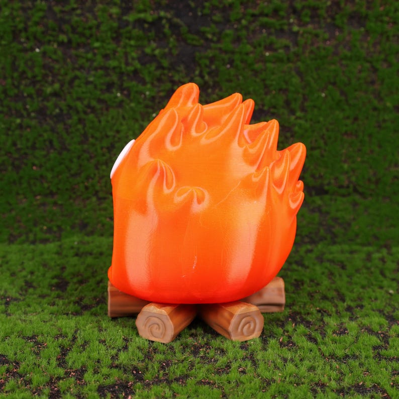 Scene showing the Calcifer fire demon desk organizer open with small gadgets like flash drives and memory cards stored inside. The design brings Howl’s Moving Castle magic to any desk or workspace. Ideal for students, professionals, or anime fans, this organizer combines whimsical aesthetics with daily practicality and makes an eye-catching gift option for holiday seasons.