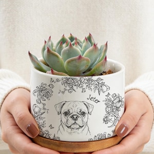 Könnte beinhalten: Ein Set aus drei Keramikbechern mit gesprenkelter, matter Oberfläche. Die Becher sind in Creme-, Hellgrau- und Dunkelgrautönen gehalten. Jede Tasse hat ein schlichtes, minimalistisches Design.