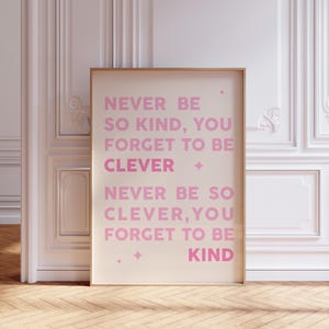 May include: A motivational poster with a pink and white color scheme. The text reads "Never be so kind, you forget to be clever. Never be so clever, you forget to be kind."