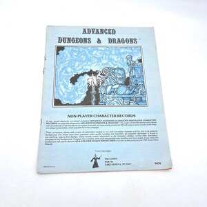 May include: A vintage Advanced Dungeons & Dragons Non-Player Character Records booklet. The cover features a blue and white illustration of a fantasy scene. Text includes the title and information about the record sheets.