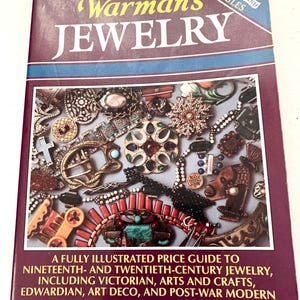 May include: A hardcover book titled "Warman's Jewelry" with a maroon cover and a blue stripe. The cover features a collage of antique jewelry pieces. The book is an illustrated price guide to 19th and 20th-century jewelry, including Victorian, Art Deco, and Post-War Modern styles.