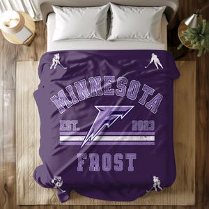 May include: Purple and white Minnesota Wild bedding with a hockey stick and player graphic. The bedding features the team's logo, the text "Minnesota", "Est. 2023", and "Frost".