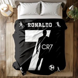 May include: Black and white blanket with a silhouette of a soccer player and the text "RONALDO" and "CR7".