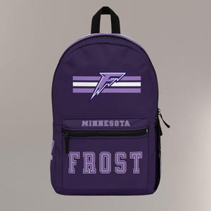 May include: Purple backpack with the word "FROST" in white block letters. The backpack has a front pocket with the word "MINNESOTA" above it. A white and purple logo is centered above the front pocket.