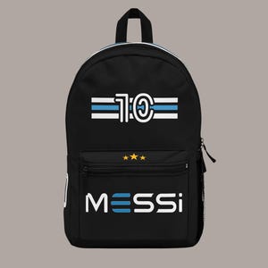 May include: Black backpack with white and blue stripes and the number "10" in a circle. The bottom of the backpack has the word "MESSI" in white with blue stripes.