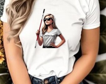 May include: White t-shirt featuring a graphic of a woman wearing sunglasses and holding a red and white cane. The graphic includes the word "Unlimited". The woman in the graphic is wearing a white t-shirt, black pants, and sunglasses.