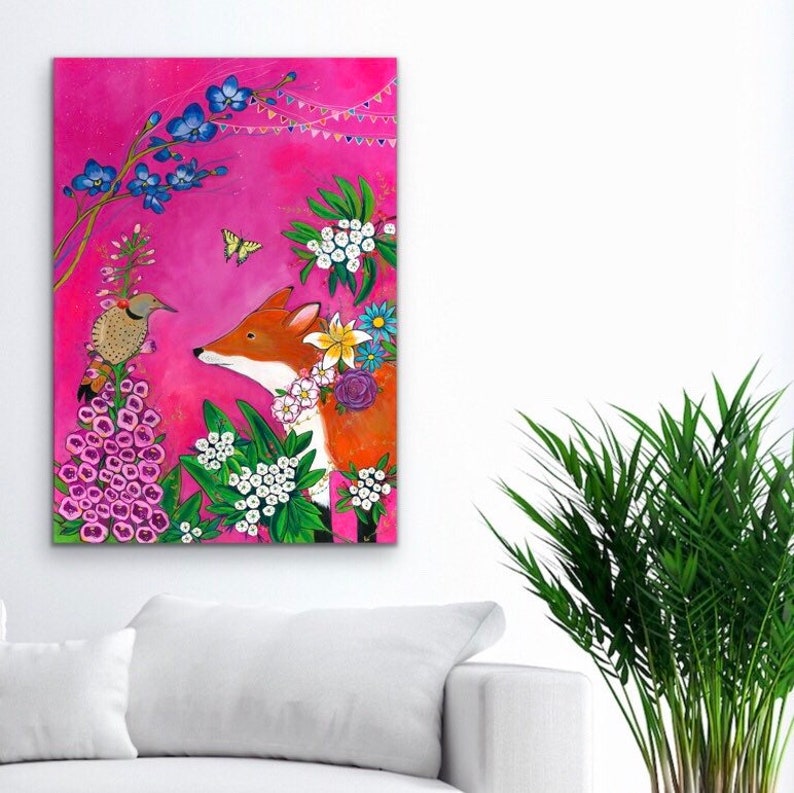 May include: A whimsical painting of a fox with a floral crown, standing in a garden with a pink background. The fox is looking at a bird perched on a flower. The painting features a variety of flowers, including white, pink, and blue.