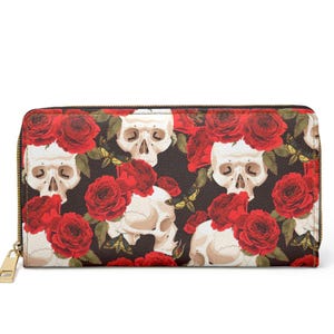 May include: A rectangular zip-around wallet featuring a repeating pattern of off-white human skulls, vibrant red roses with green leaves, and small yellow and black moths set against a solid black background with a gold-toned metal zip.